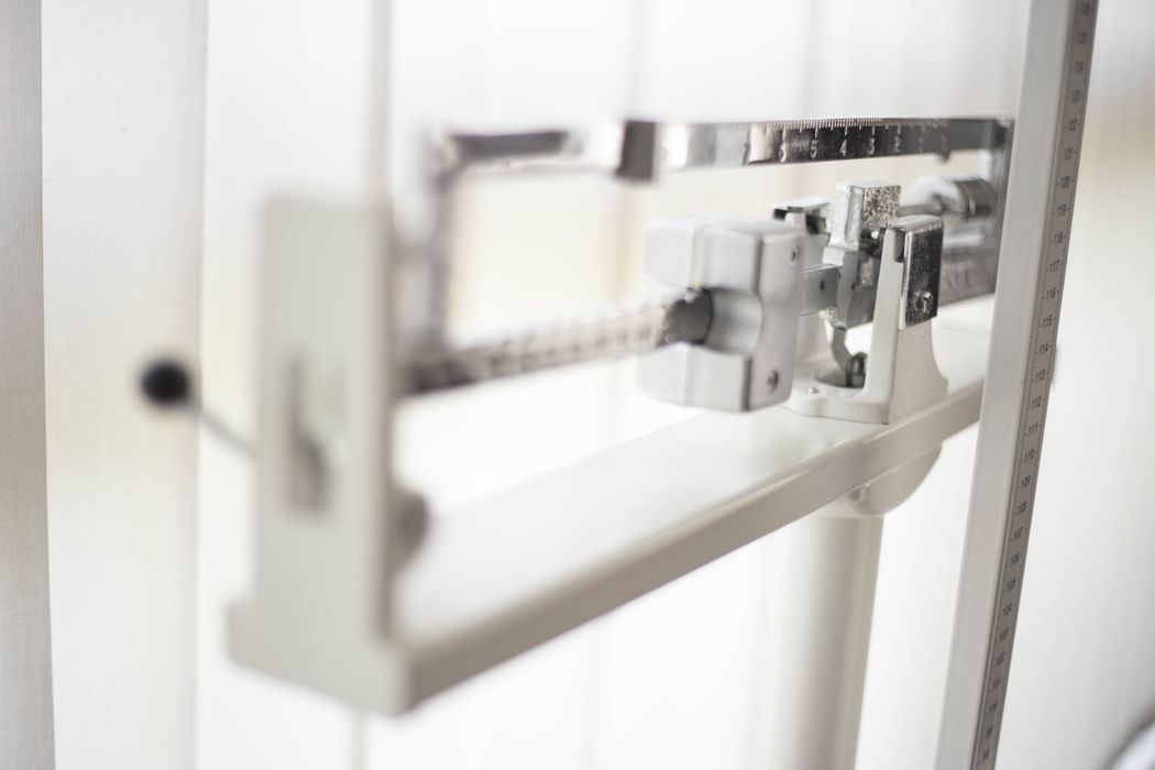Detailed view of a classic mechanical balance scale, offering precision in weight measurement.